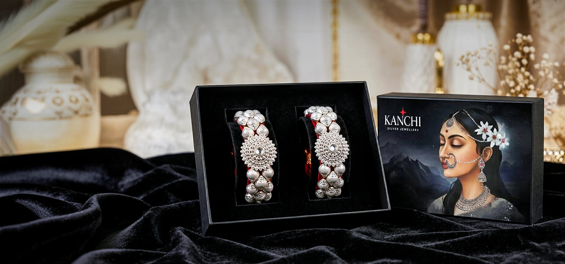 Kanchi jewelry set with black box and portrait of a woman wearing jewelry on a dark fabric background.